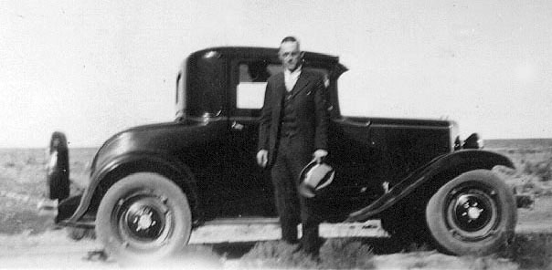 <adron with car, may be a 1930 chevy>