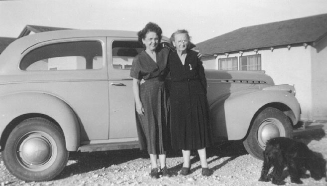 <adron Turner's sisters Bug and Lela posed with aunt lizzie's grey chevy, original color was maroon. posed in front of uncle george's house at house, NM>