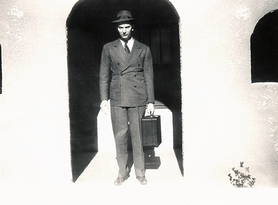 < uncle rubus carrying a suitcase in doorway of ft sumner house>