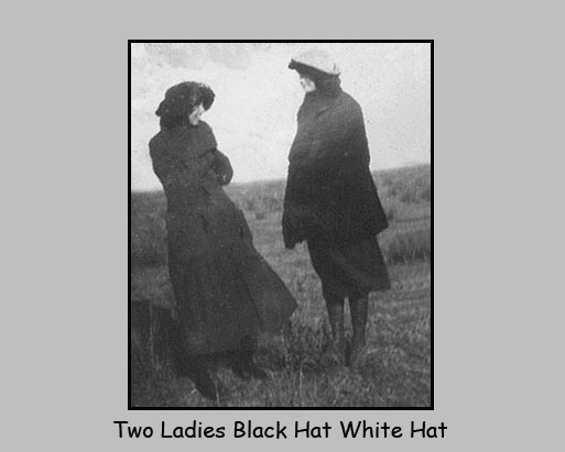 <two ladies black hat white hat>