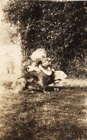 <child huging a dog>