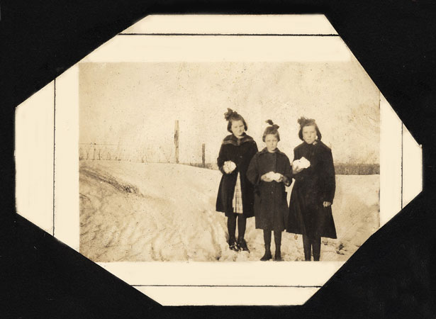<three girls holding snowballs>