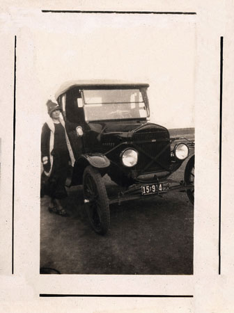 <johnie standing by a model a>