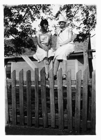 <Pauline and Vesper sitting on a fence restored by terry>