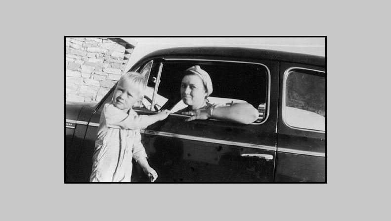 <Terry and his Mom, Johnie. 1940 Ford at possible location, George Turner's rock house, which was located some distance South of Adron Turner's Diamond A Ranch...>